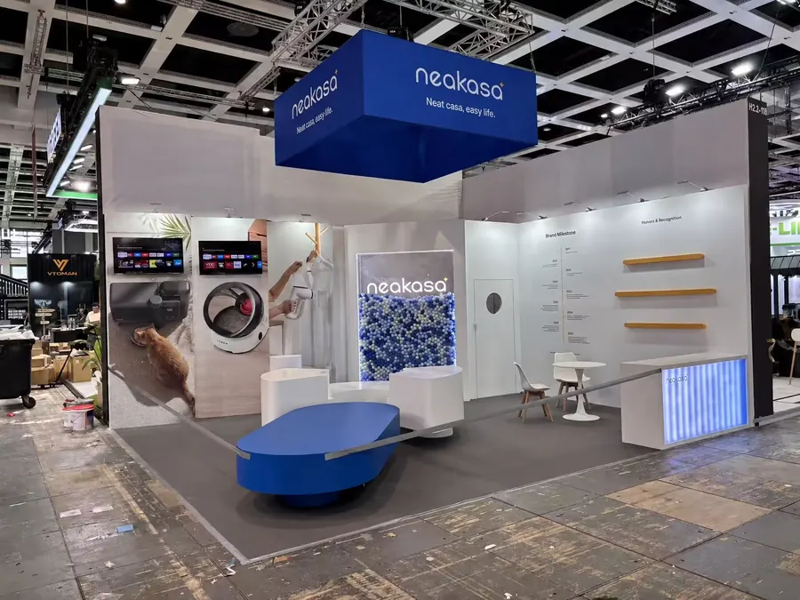 Blue suspended sign above product plinths and a reception counter