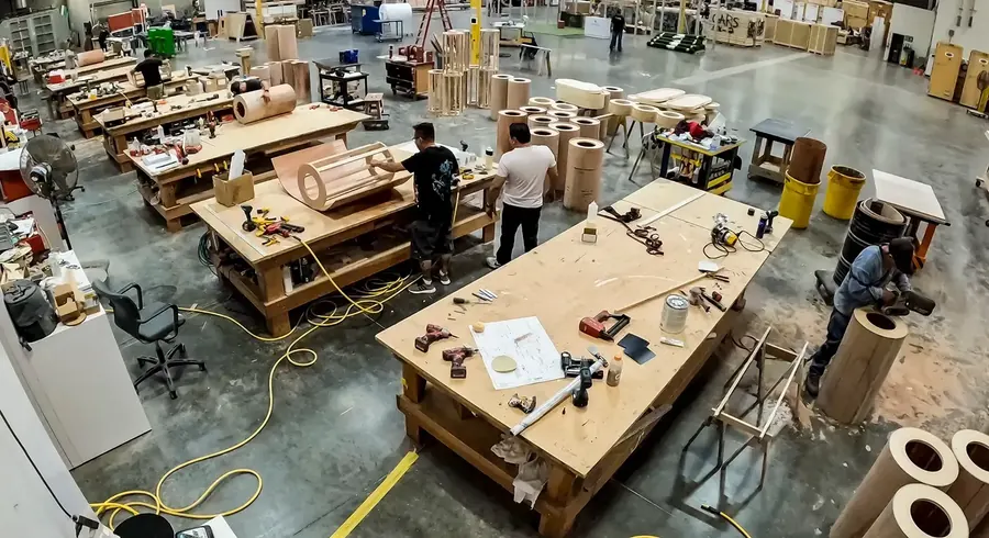 Woodworking area with curved timber components and workbenches